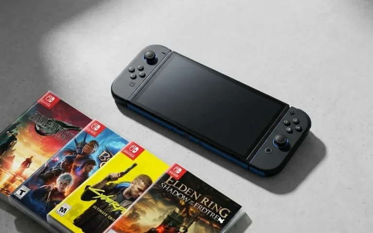 A matte black Nintendo Switch 2 console resting on a concrete surface next to fanned-out physical game cases for Final Fantasy VII Rebirth, Baldur's Gate 3, Cyberpunk 2077, and Elden Ring.