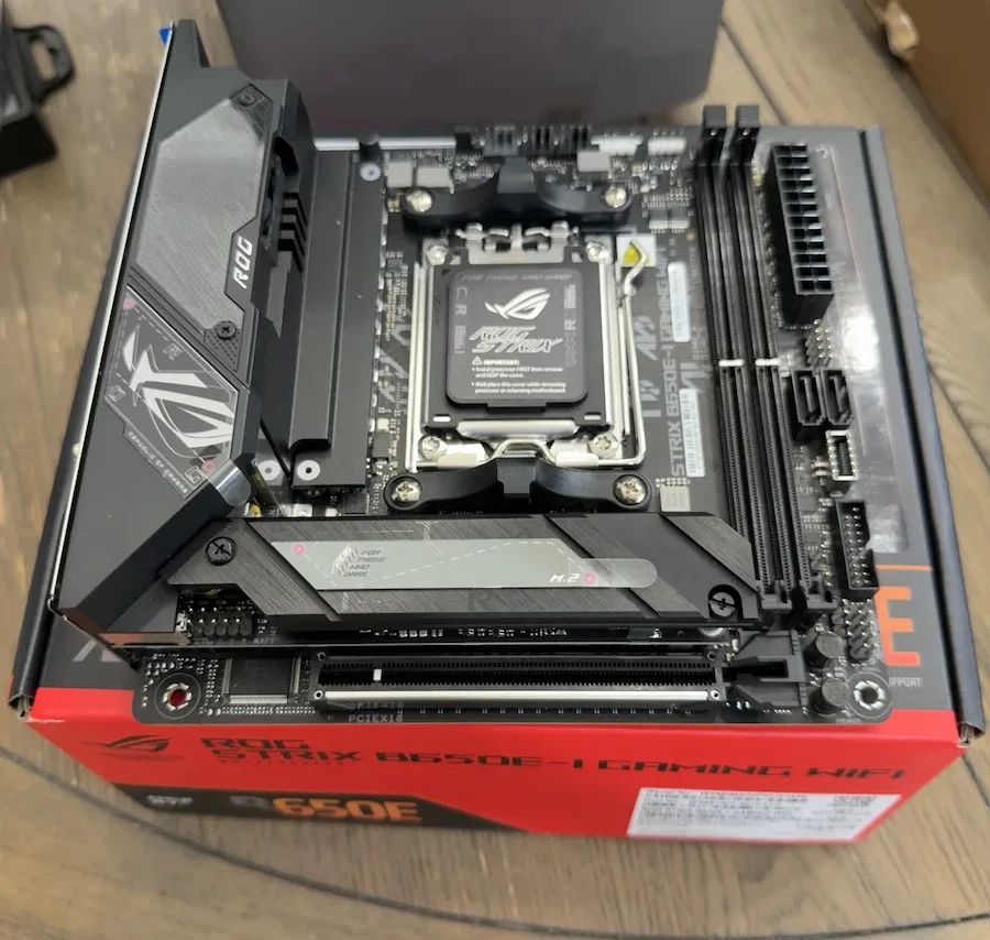 ASUS ROG Strix B650E-I Gaming WiFi Mini-ITX AM5 motherboard sitting on its retail box