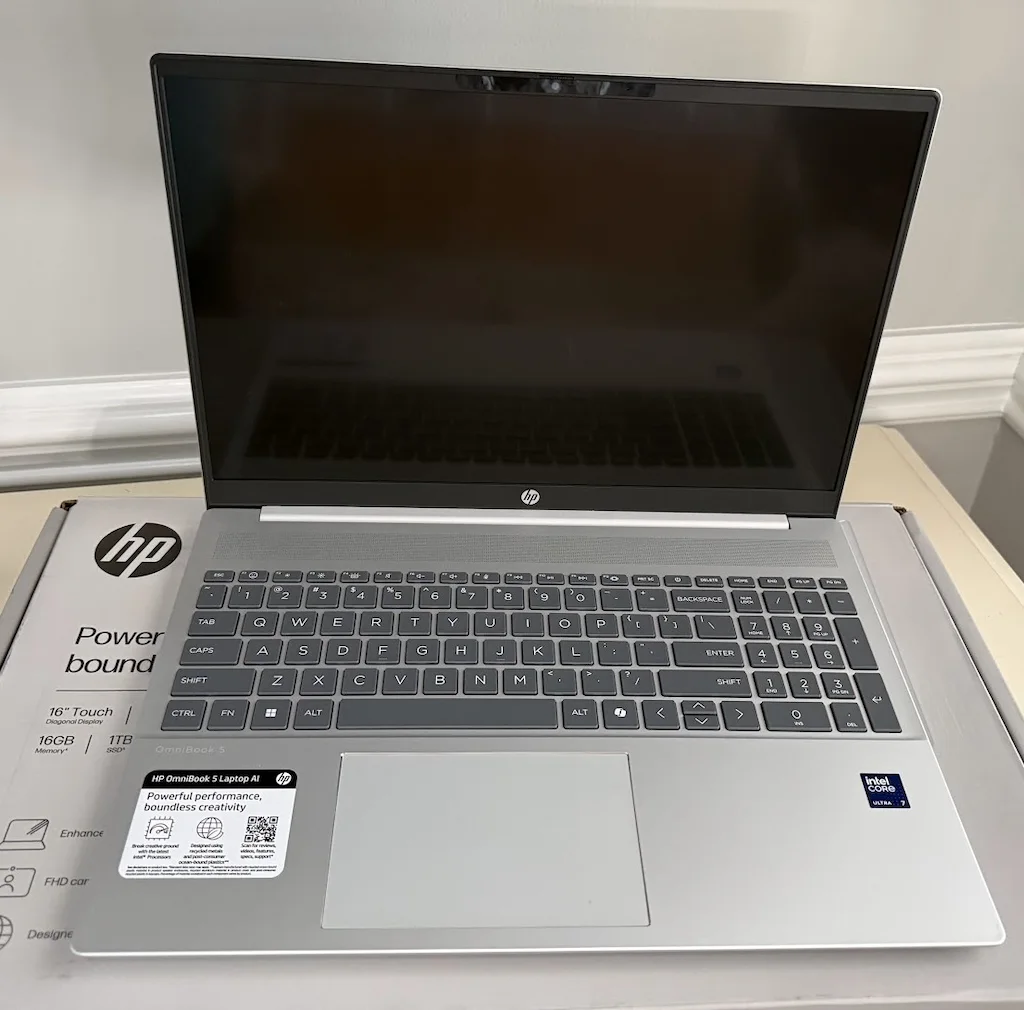HP OmniBook 5 16-af1017wm open laptop with keyboard, touchscreen display, and Intel Core Ultra 7 branding