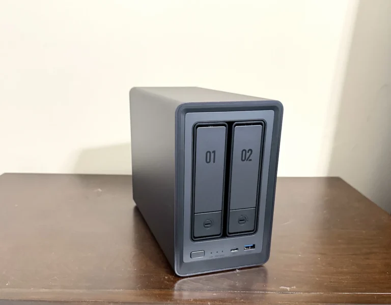 UGREEN NASync DXP2800 2-bay NAS photographed from a front three-quarter angle, showing both drive trays and front USB ports.